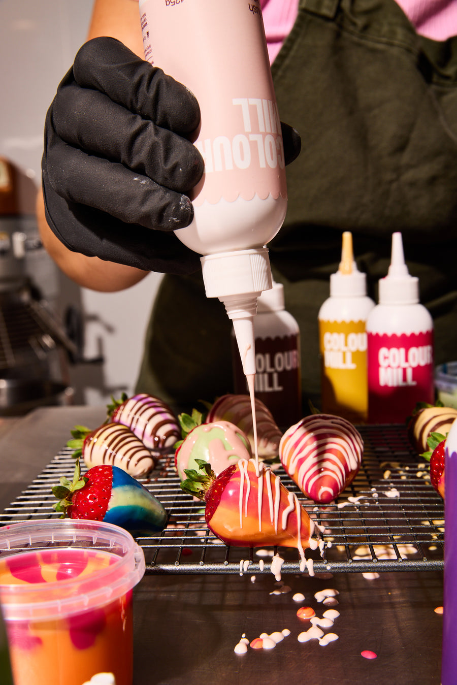 Drizzling chocolate covered strawberries with Blush coloured Chocolate Drip by Colour Mill